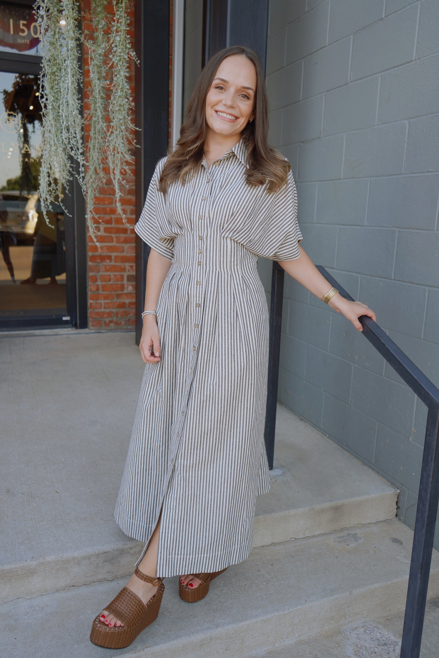 Model wearing striped shirt dress